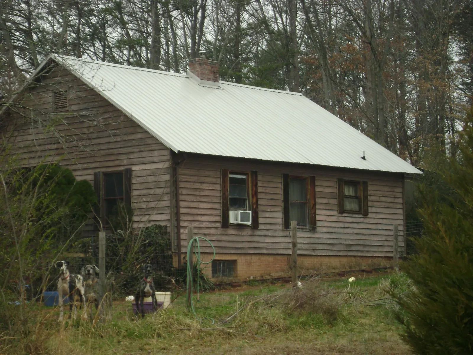 White metal roof on an old wood sided farmhouse, from a Metal Roof Installation job in Kirkersville